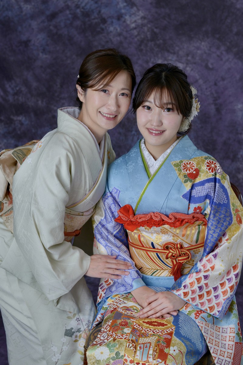 Coming-of-age parent and child studio portrait